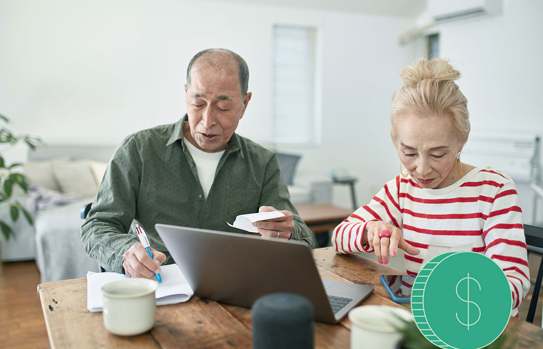 senior couple going over finances in front of computer